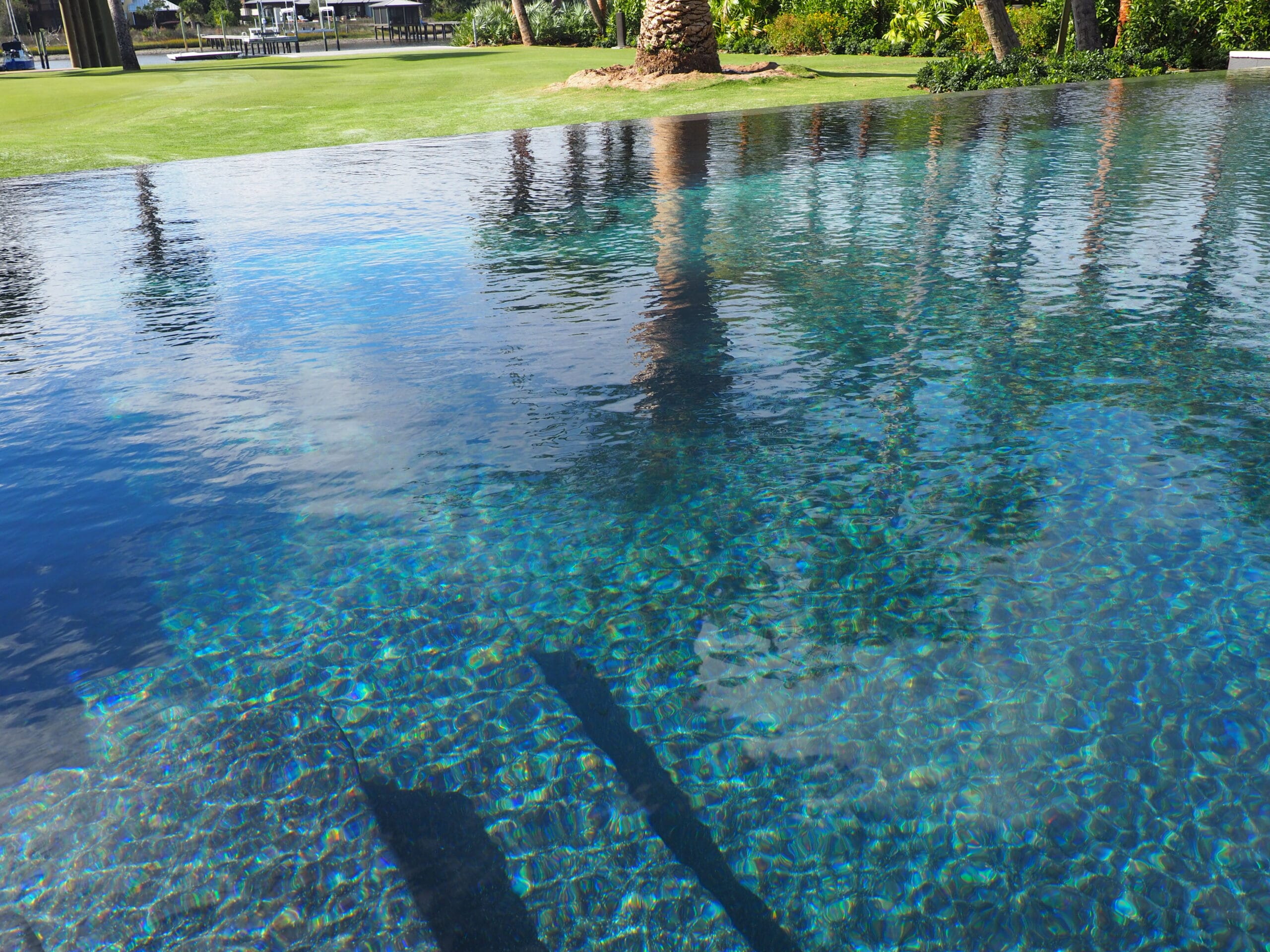 pool rejuvenation cleaning Jacksonville FL - A close-up of a clear blue swimming pool with sparkling water, highlighting the