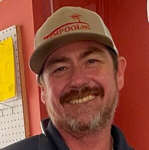 Brian Tempool smiling in a professional setting, showcasing his expertise and approachability.