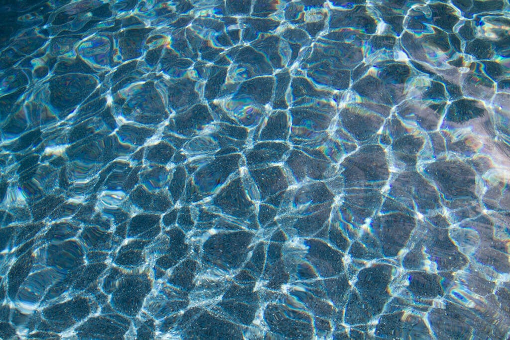 A clear swimming pool with visible water flow, illustrating proper water circulation in swimming pools.