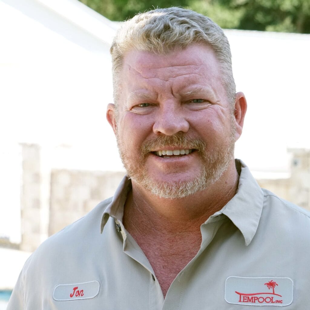 A smiling professional with expertise in pool plastering, representing pool plastering experts in Jacksonville FL.