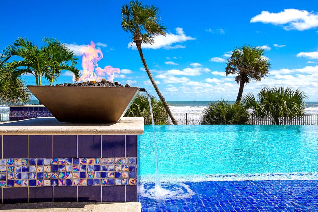 A beautifully finished cove blue pool showcasing smooth plastering, highlighting pool plastering in Ormond Beach.