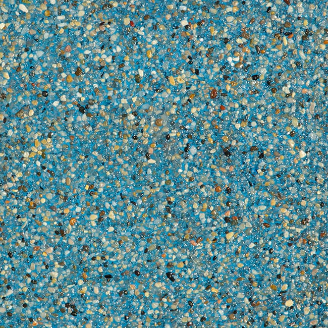 choosing pool colors and textures Jacksonville FL - A close-up view of small pebble pool finish, showcasing various colors an