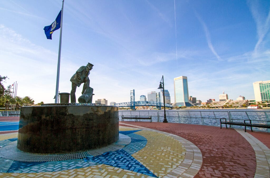 A detailed view of a statue in downtown, part of the Haskell Company fountain project, surrounded by greenery.
