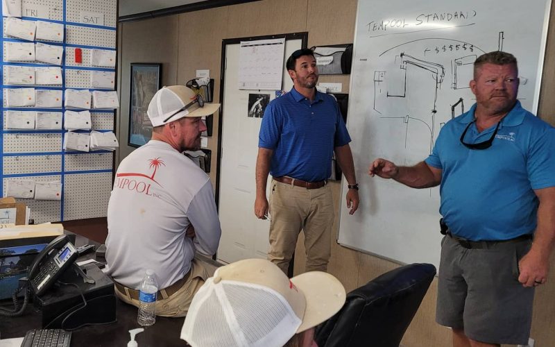 A professional inspecting freshly plastered pool surfaces, emphasizing pool plastering consulting Jacksonville FL.