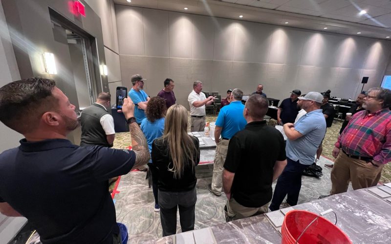 pool plaster training Jacksonville FL - A trainer demonstrating pool plaster techniques to students during a session in Jacks