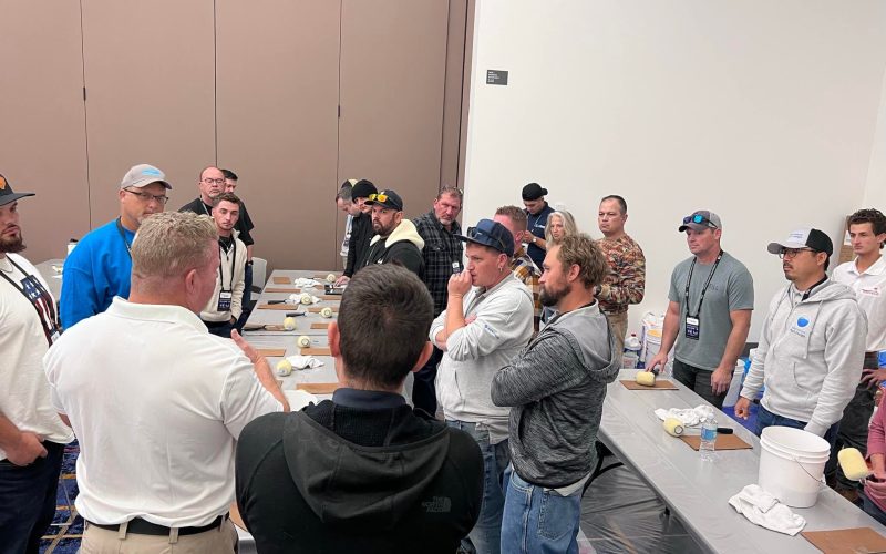 pool plaster training Jacksonville FL - A group of trainees practicing pool plastering techniques outdoors in Jacksonville, F