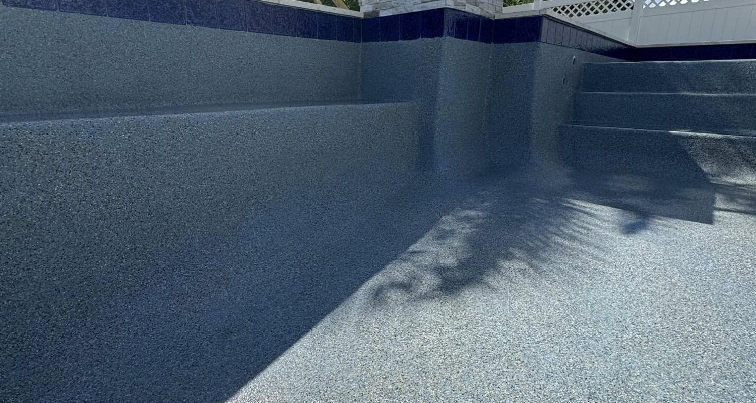 pool plaster product development Jacksonville FL - A close-up of a smooth, freshly applied pool plaster showcasing its textur