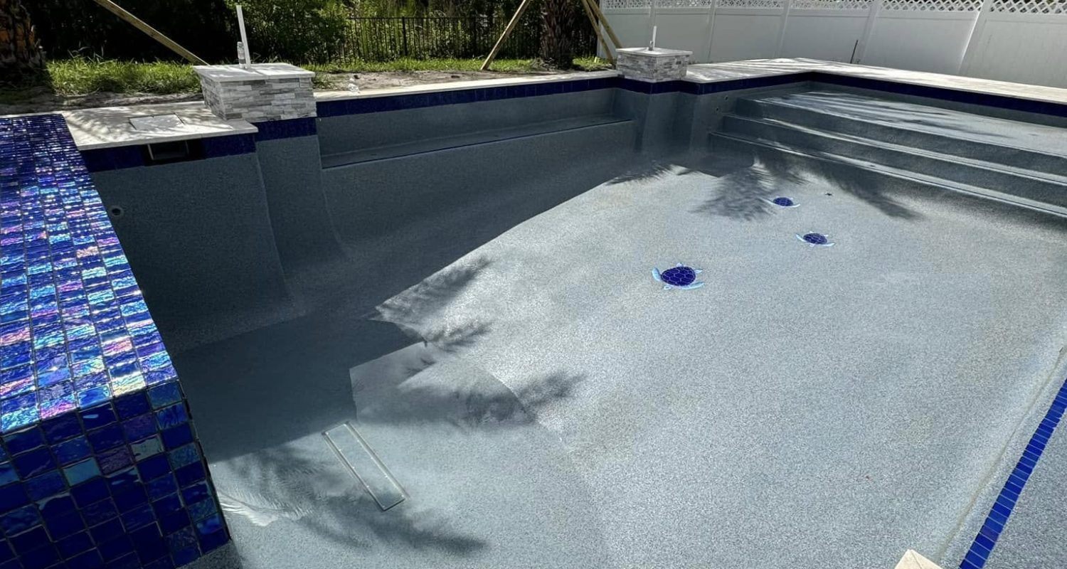 pool plastering services jacksonville fl - A newly plastered pool showcasing smooth, white surfaces under bright sunlight, hi