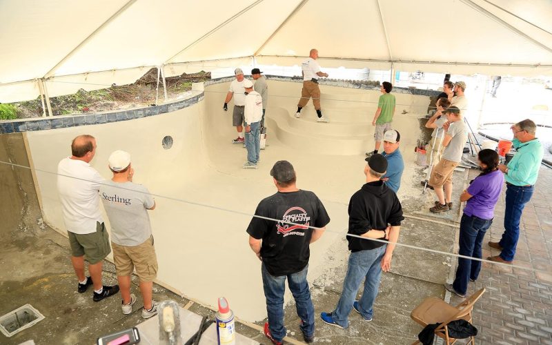 Training session for pool plastering experts in Jacksonville FL, showcasing techniques and tools used in the process.